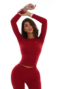 Woman wearing a red activewear Long Sleeve Top on a white background