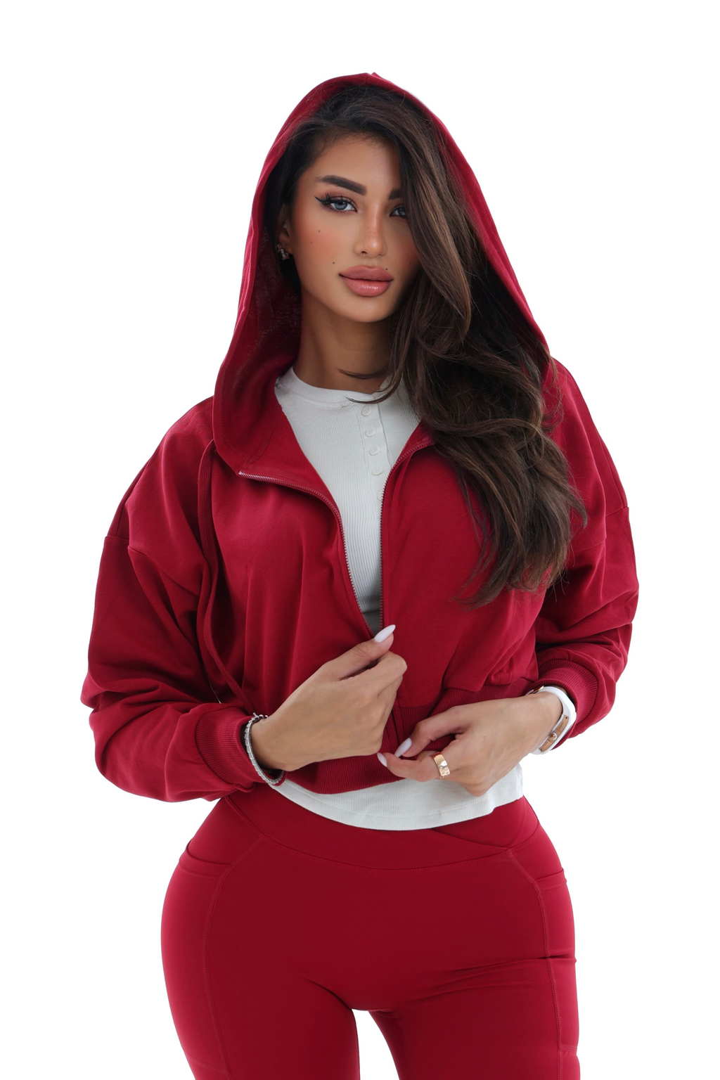 Woman wearing a red activewear hoodie on a white background