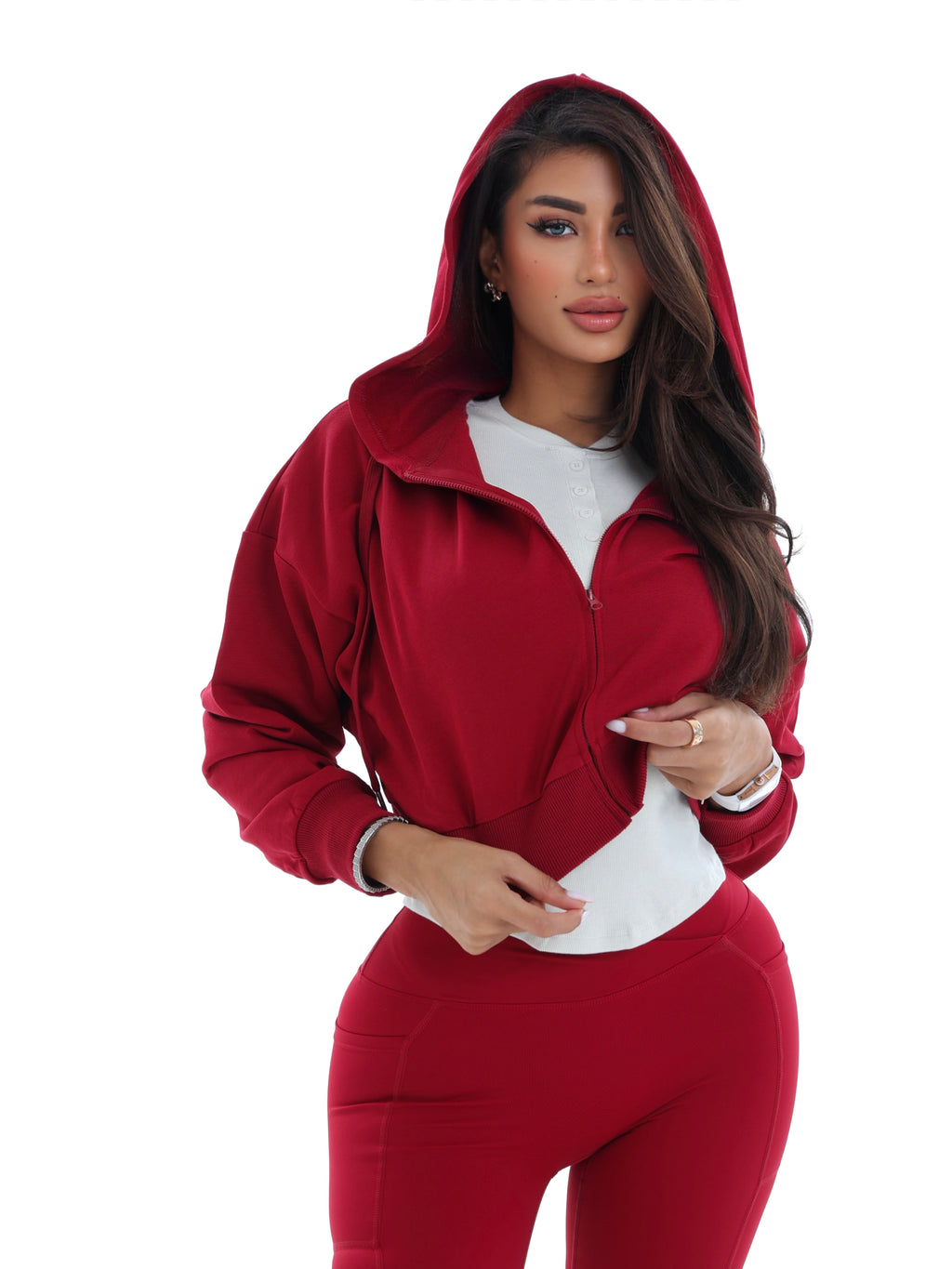 Woman wearing a red hoodie and matching pants on a white background
