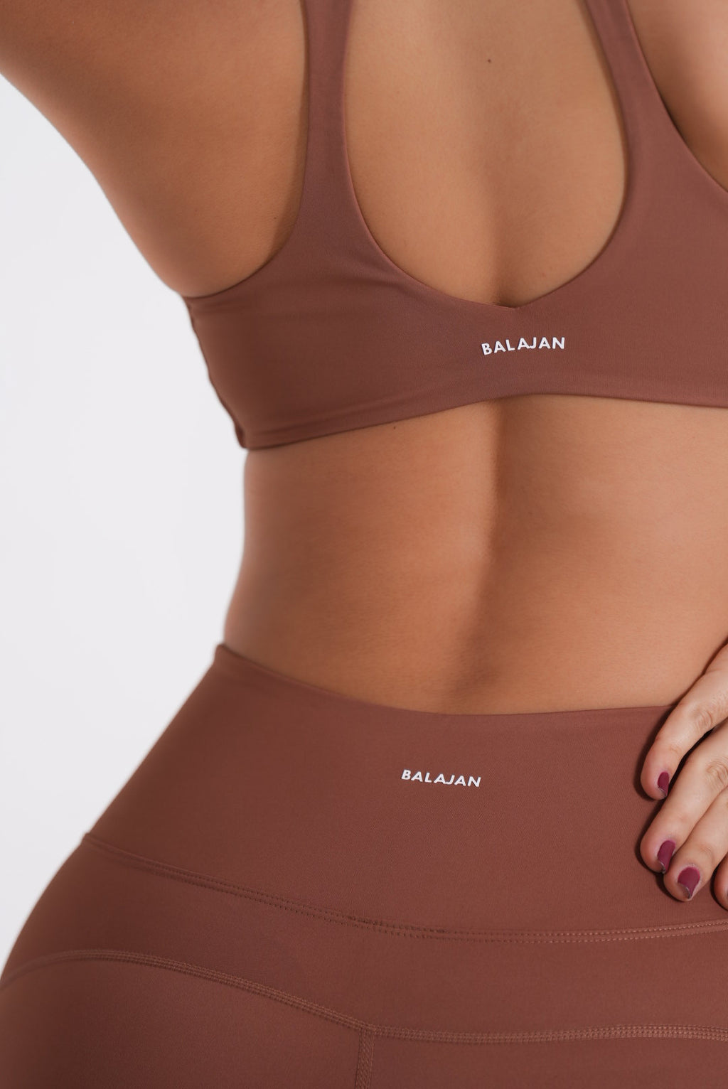 Brown sports bra and Eterna Wave Leggings' with 'Balajian' branding on a white background