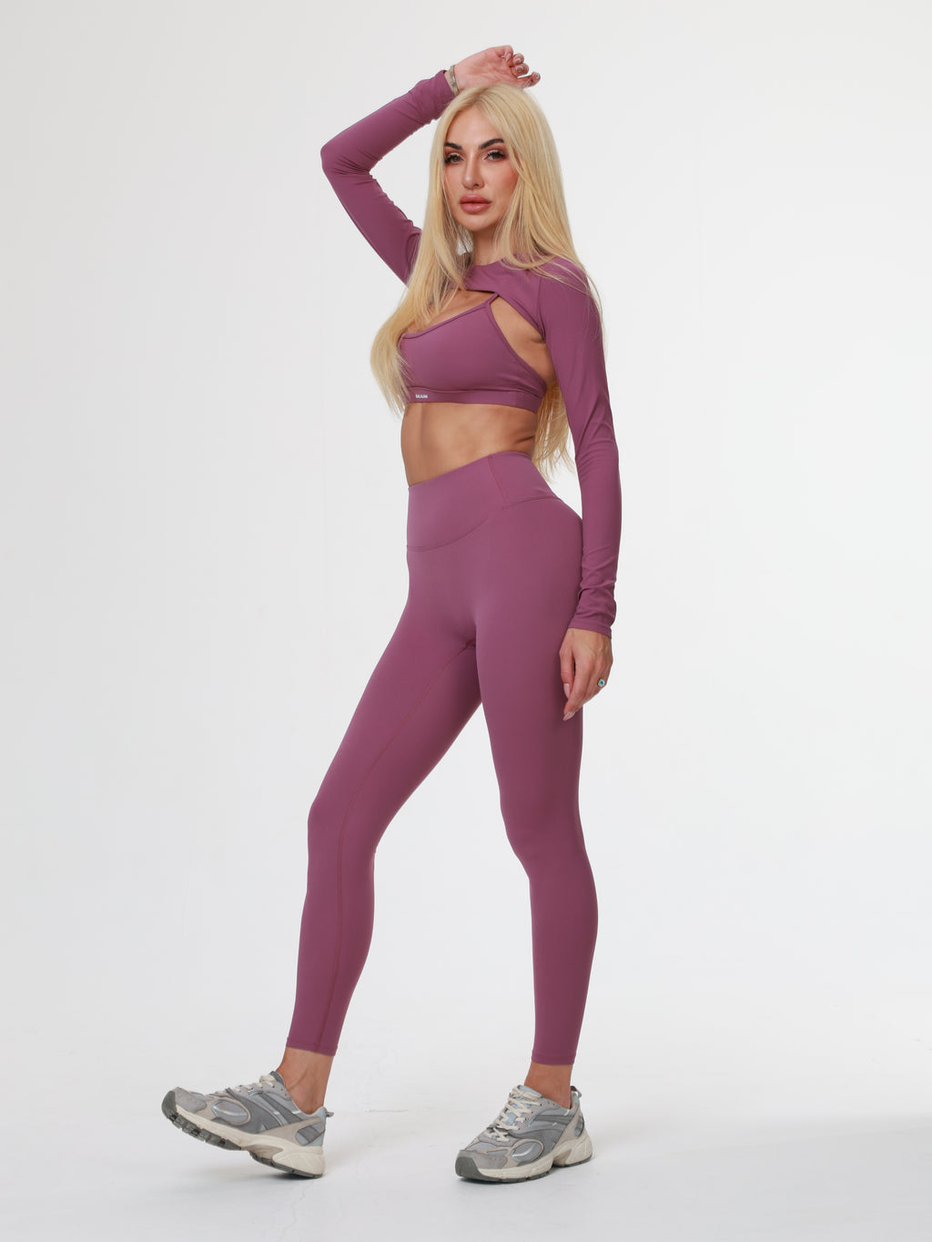 Person wearing a purple athletic Amethyst Leggings posing on a white background