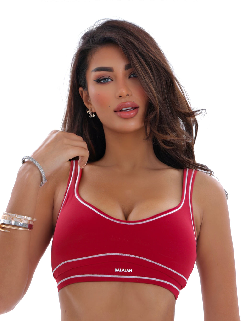 Woman wearing a red sports bra with 'Balajan' branding on a white background