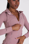 Person wearing a pink hooded Core Sol Jacket' on a white background