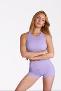 Woman wearing a purple athletic Flux Shorts' on a white background