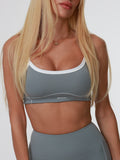 Woman wearing a gray Storm Motion Top bra and leggings on a white background