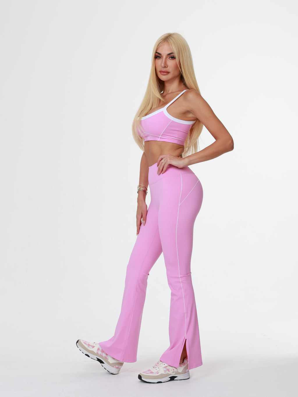 women wearing pink Woman in pink flare leggings lying on a white background